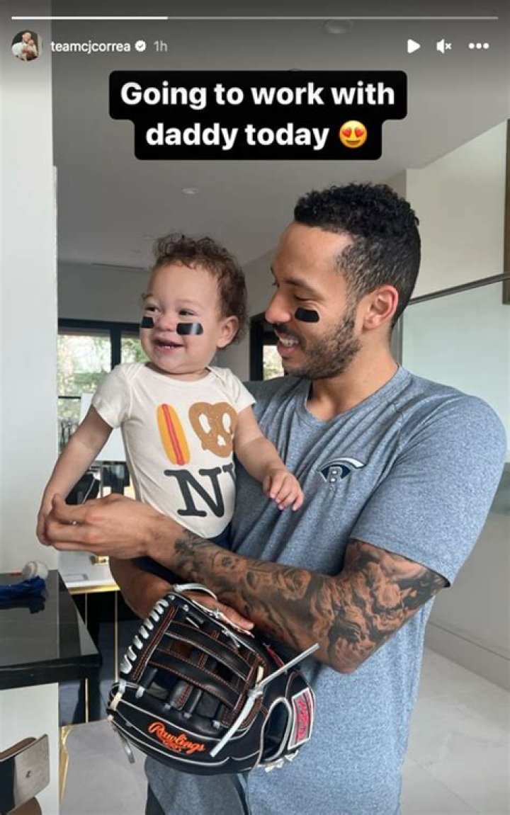 Carlos Correa is holding a baseball bat in his hand.