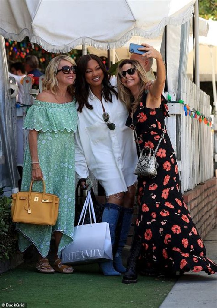 Sutton Stracke taking a selfie with her Tiara and the custom Couture, from Dolce & Gabbana, in her car.